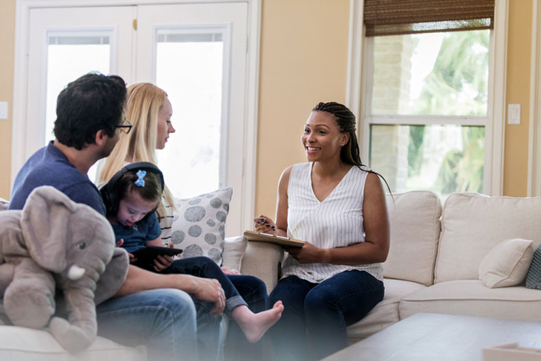 child welfare social worker at home with family