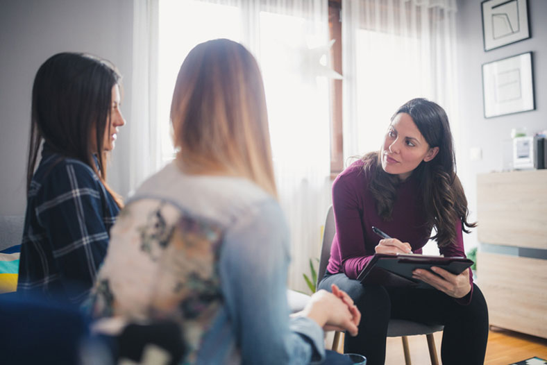 social worker meeting at home with couple