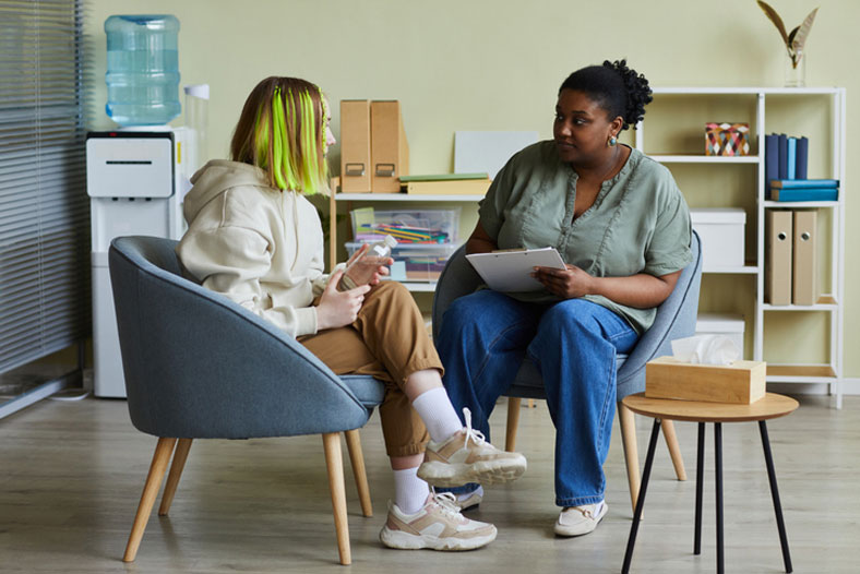 social worker and teen girl talking