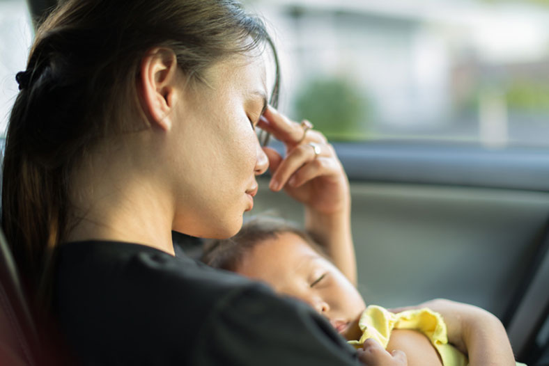 stressed mother holding baby