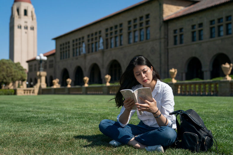 studying alone in the campus grass